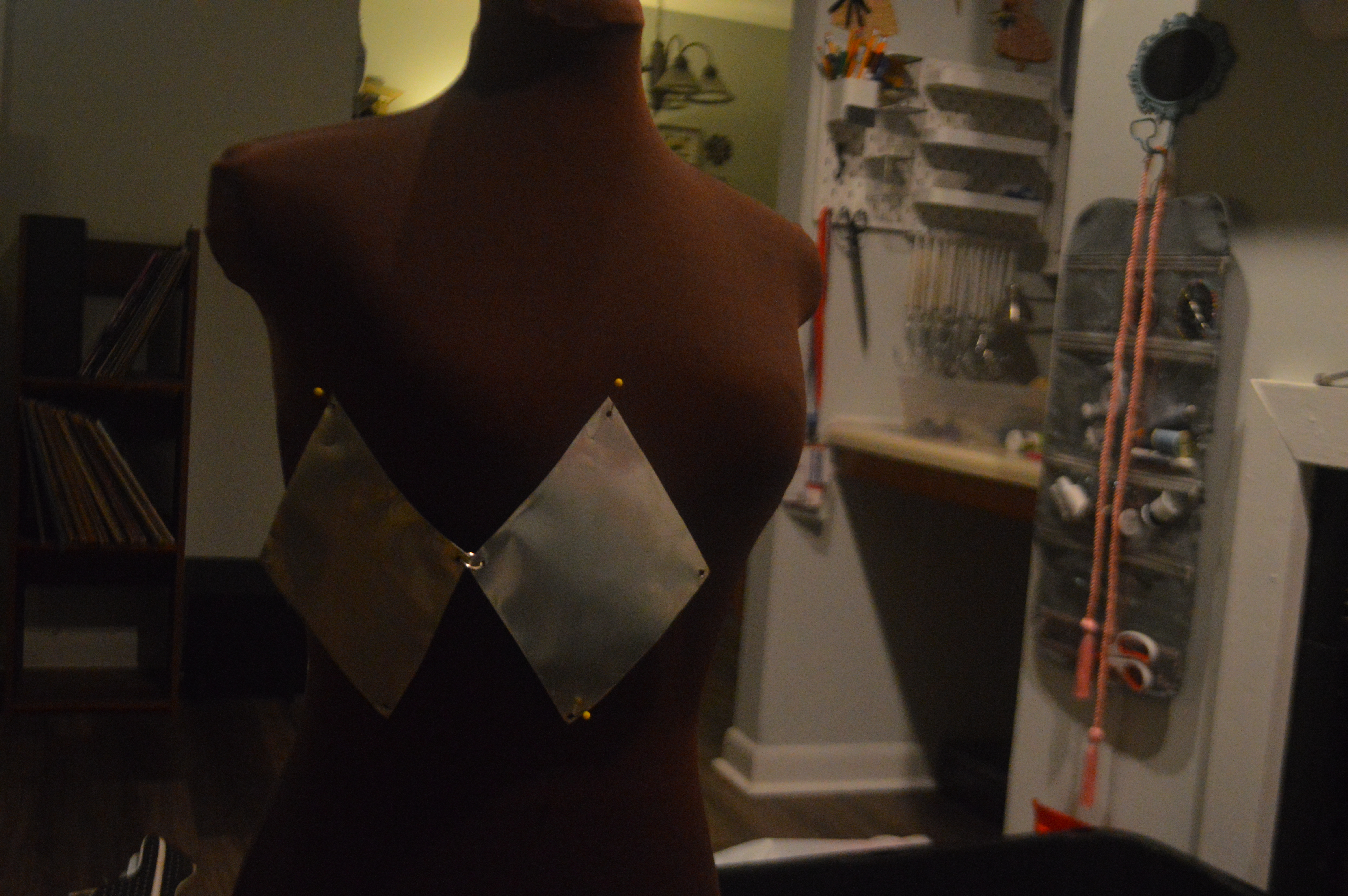 Aluminum diamonds pinned to a dress form during construction.