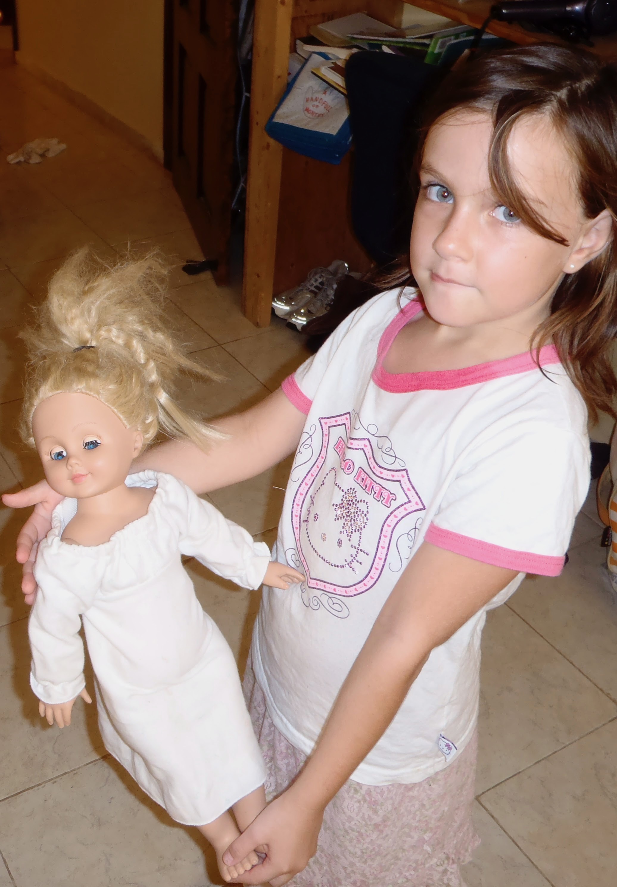 Childhood photograph of Bee Mangine holding a doll.