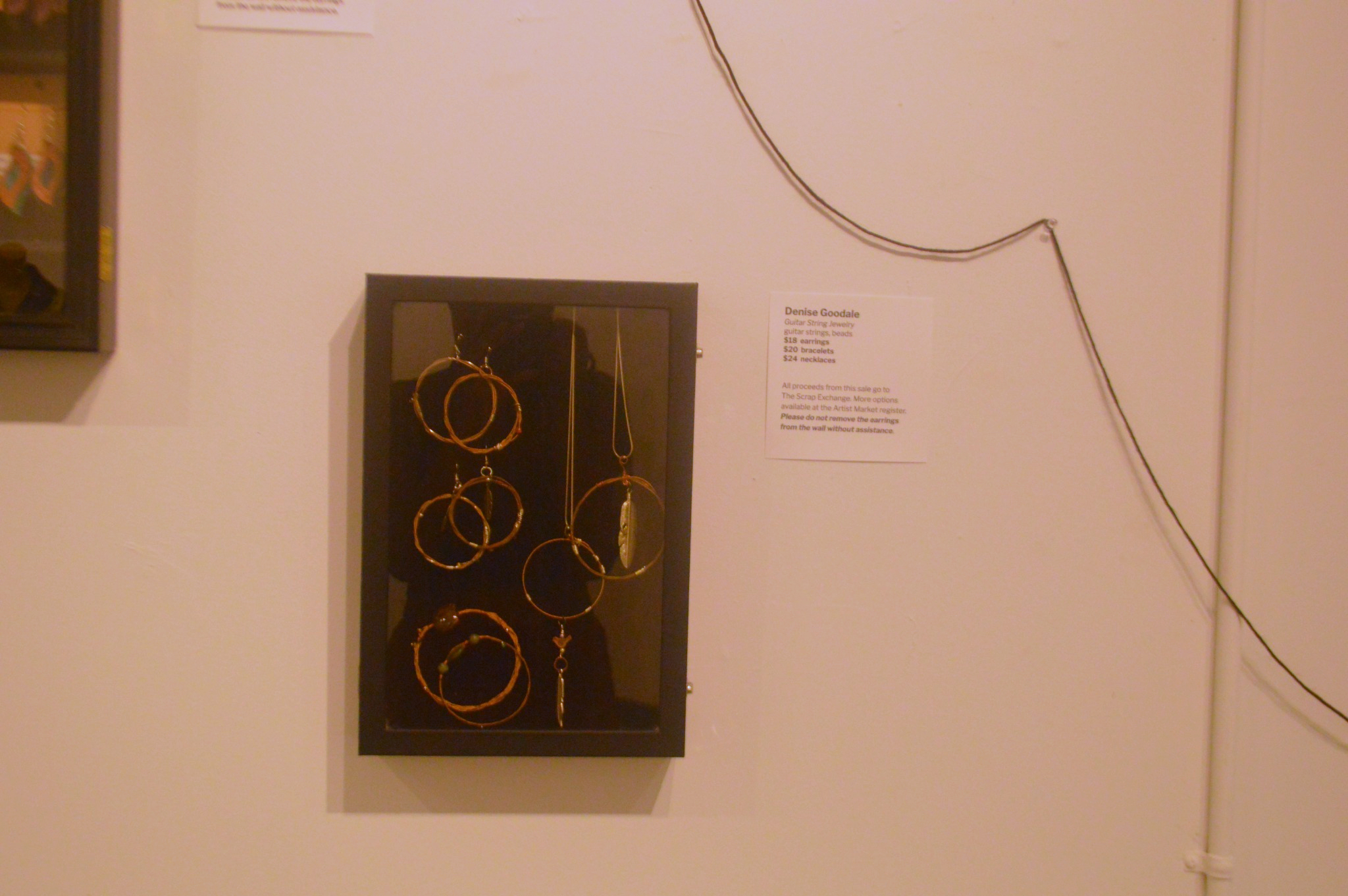 Guitar-string jewelry by Denise Goodale displayed in the exhibition.