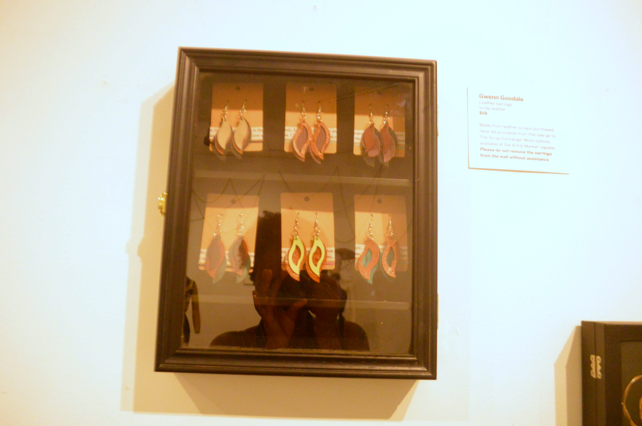 Leather earrings by Gwenn Goodale displayed in the exhibition.